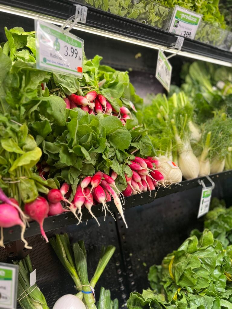 photo of fresh radishes on the produce shelves at the brattleboro food co-op