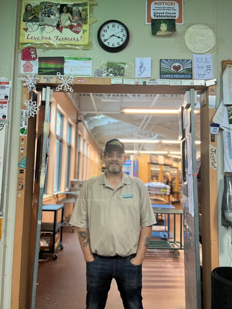 A photo of Tim, one of the BFC Produce Department employees, standing in the doorway of the produce back room.