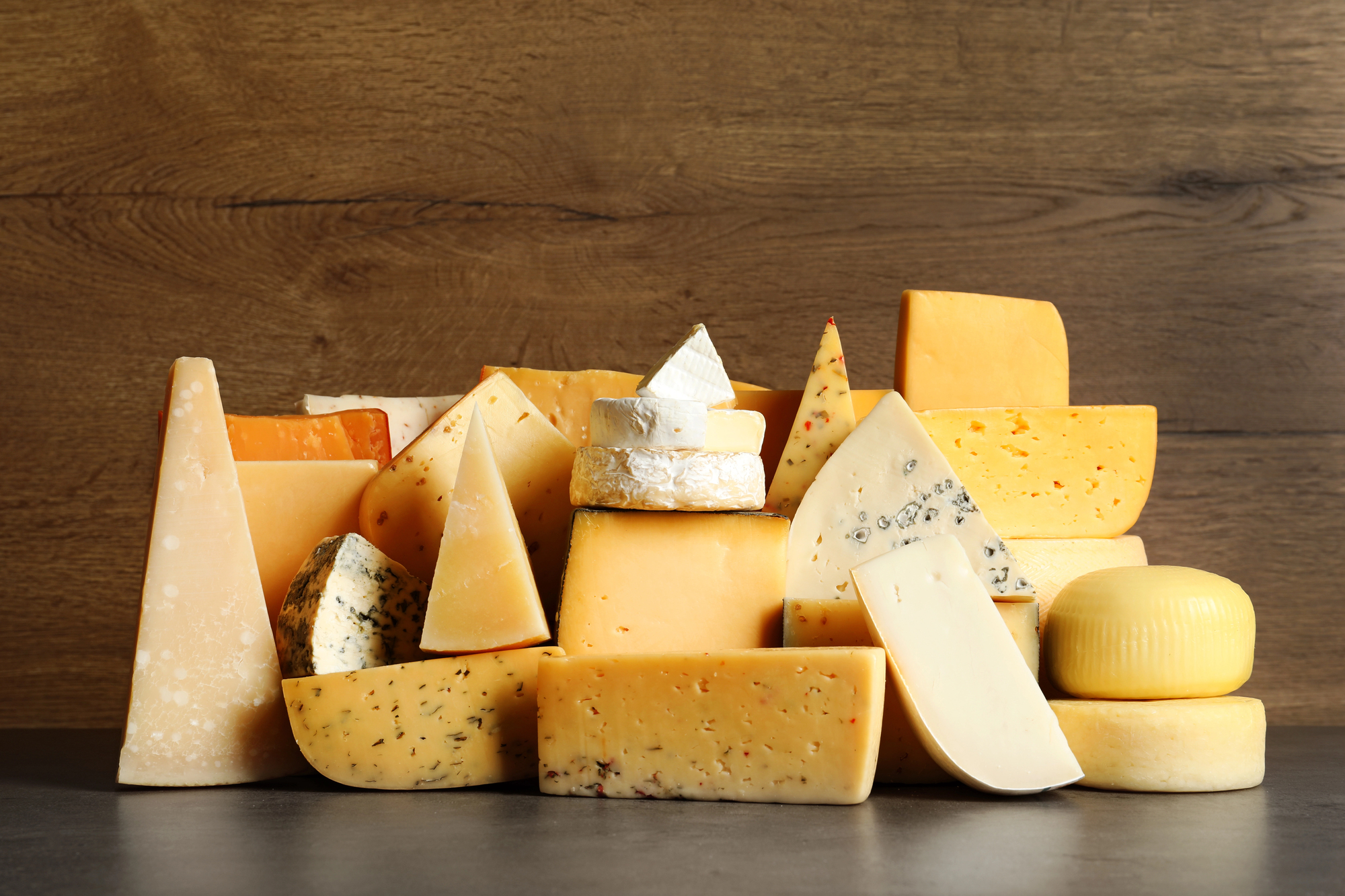 many wedges of cheese stacked in a loose geometric shape