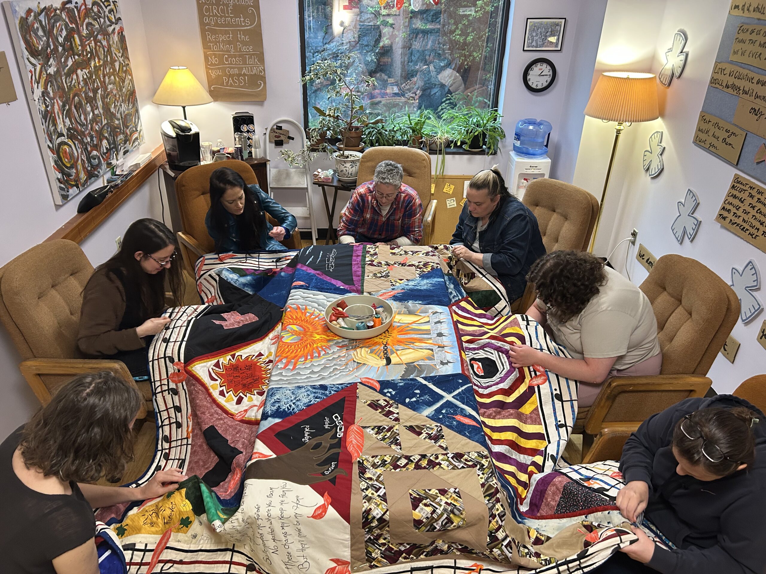 A group of people working on a quilt